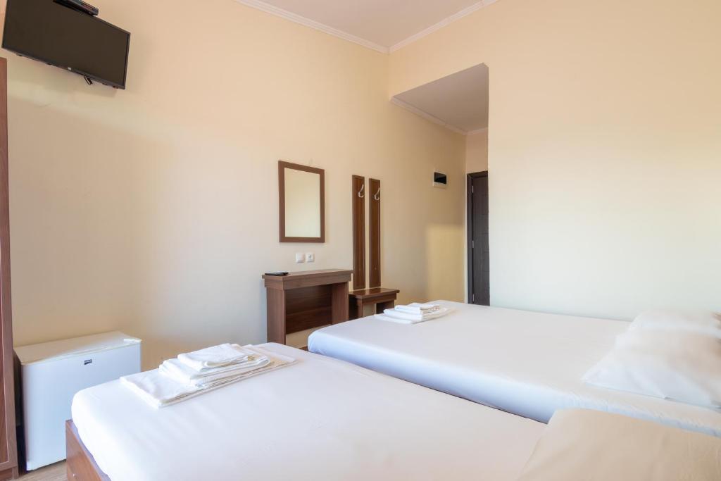 Postel nebo postele na pokoji v ubytování Myrodato Rooms