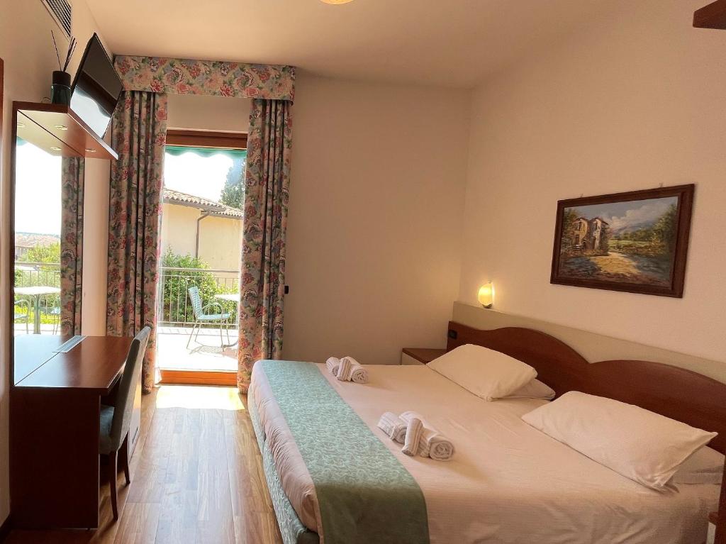 Een bed of bedden in een kamer bij Hotel Meridiana
