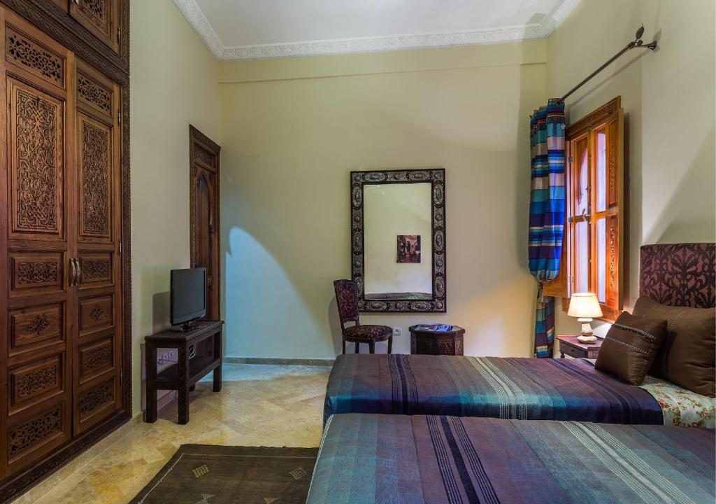Postel nebo postele na pokoji v ubytování Riad Des Nations