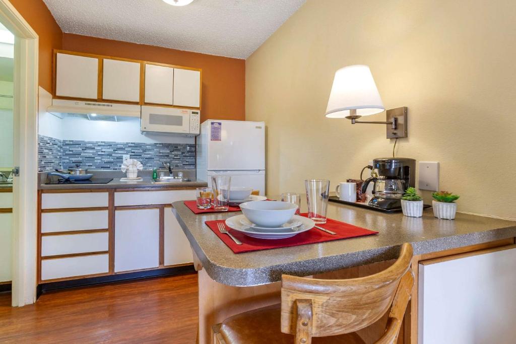 a kitchen with a table with a bowl on it at Suburban Studios in Albuquerque