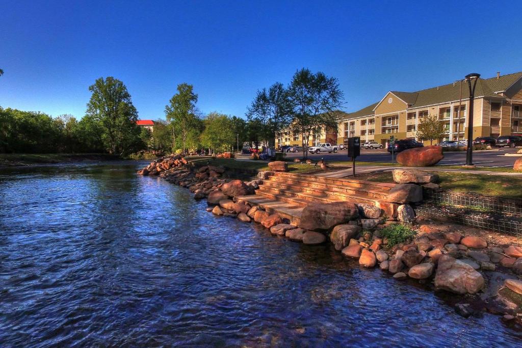 a river with rocks on the side of a street at Econo Lodge Pigeon Forge Riverside in Pigeon Forge