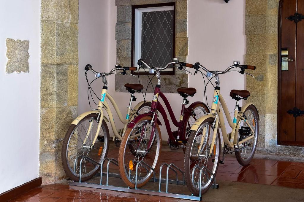 a group of three bikes parked next to a door at Hotel Fortaleza do Guincho Relais & Châteaux in Cascais