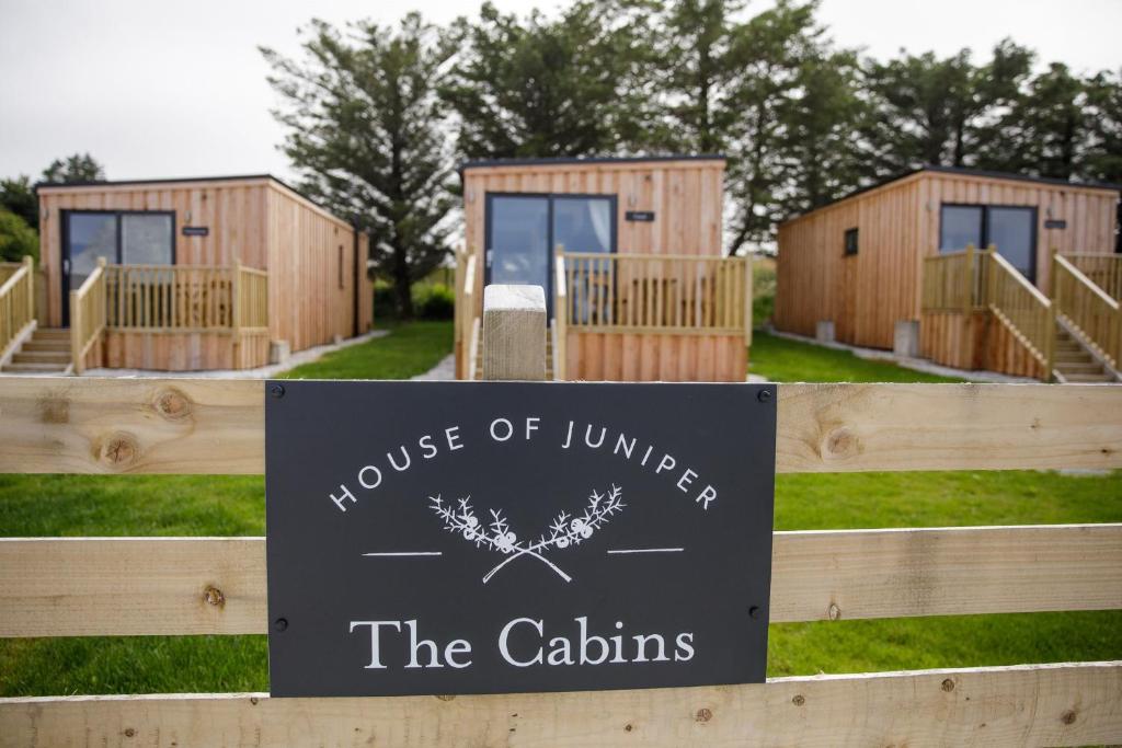 a sign for a house of linders the cottages at The Cabins - House of Juniper in Broadford