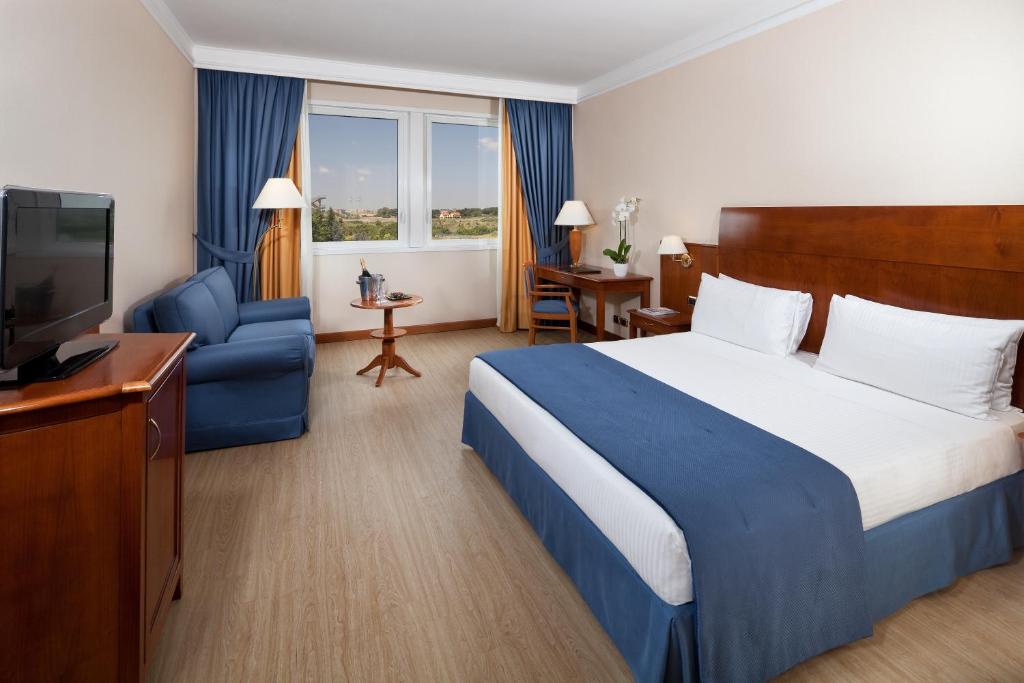 Postel nebo postele na pokoji v ubytování Hotel Roma Aurelia Antica