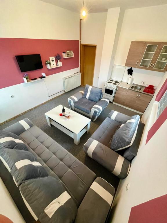 a living room with a couch and a table at Apartman Start in Pale
