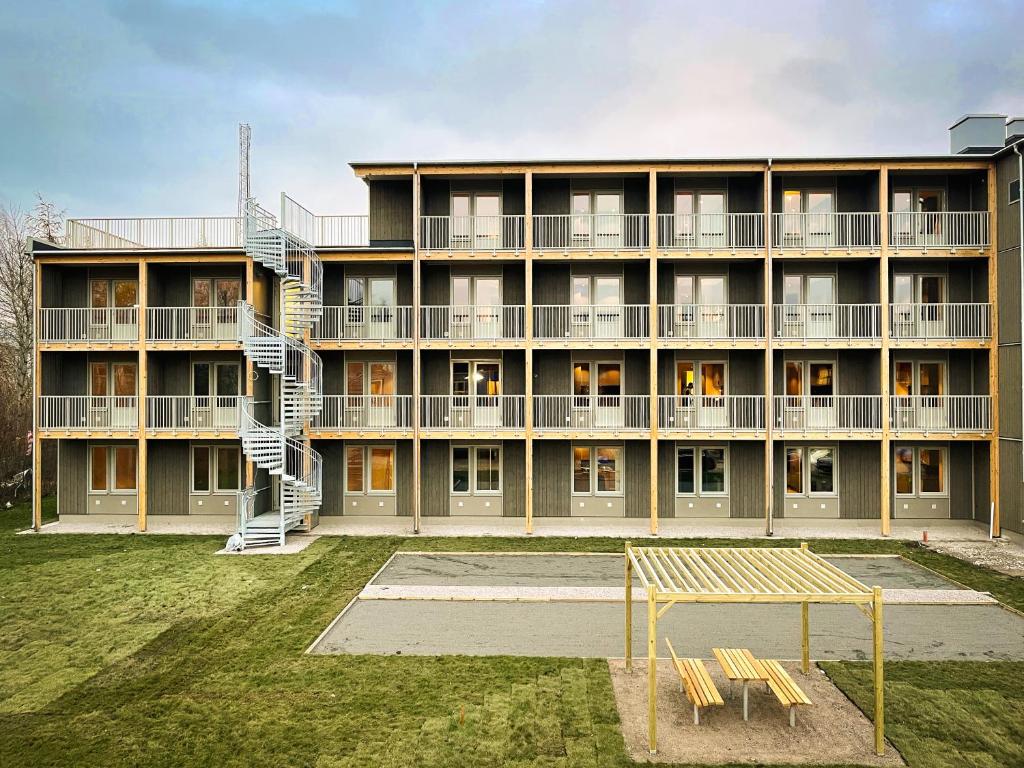 an apartment building with a playground in front of it at Uppsala Hotel Apartments in Uppsala