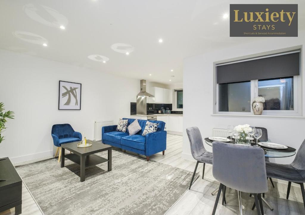 a living room with a blue couch and a table at City Centre - Modern Apartment - by Luxiety Stays Serviced Accommodation Southend on Sea - in Southend-on-Sea