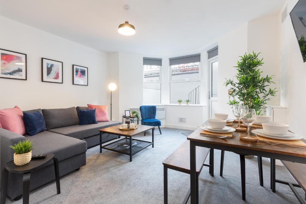 a living room with a couch and a table at Charles Alexander Short Stay - Charnley House Apartments in Blackpool