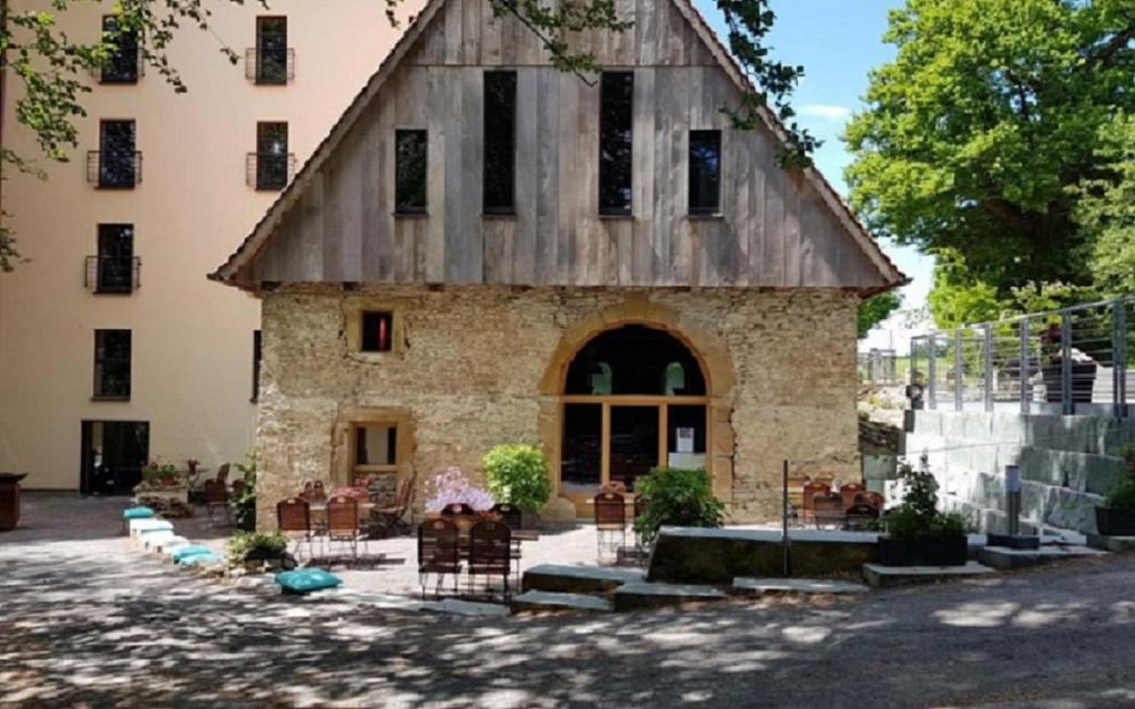 un gran edificio de piedra con techo de madera en Wassermühle Deppendorf en Bielefeld