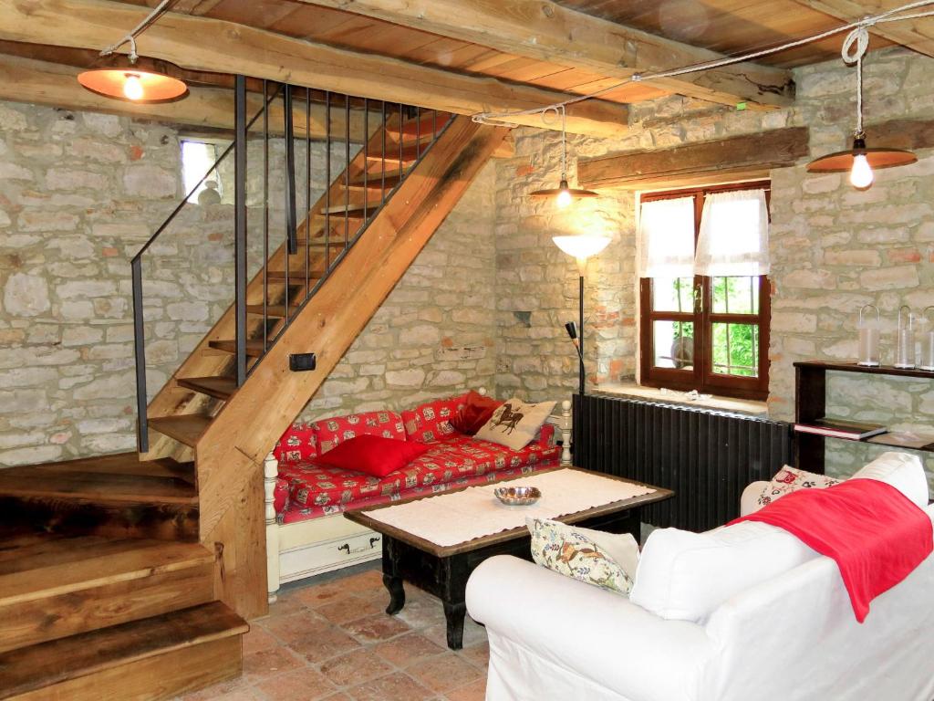 salon z czerwoną kanapą i schodami w obiekcie Holiday Home Casetta by Interhome w mieście Cortemilia