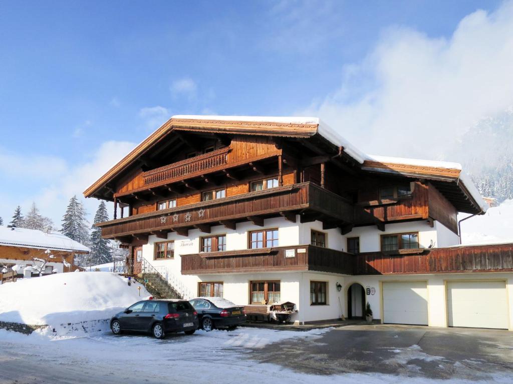 a large building with cars parked in front of it at Apartment Elisabeth by Interhome in Alpbach