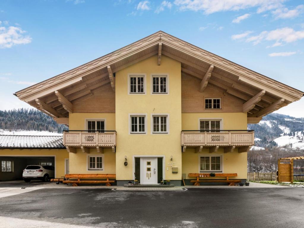 a large yellow building with a balcony at Apartment Achtalgut-1 by Interhome in Lend