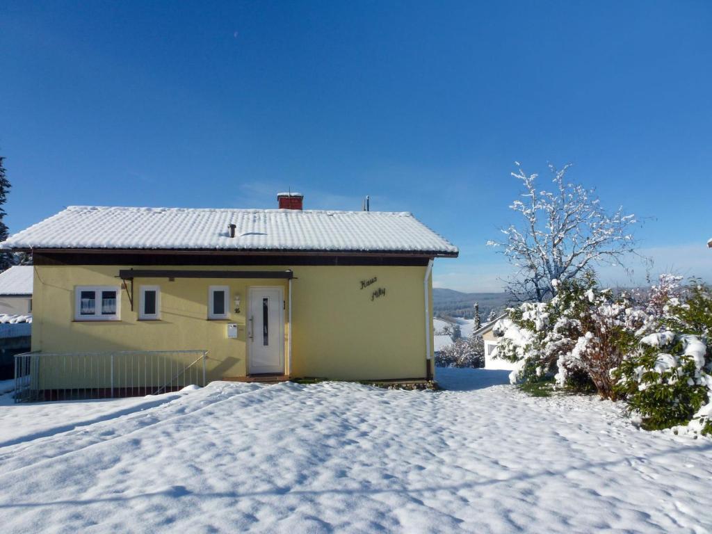 a small yellow house in the snow at Holiday Home Mily by Interhome in Dittishausen