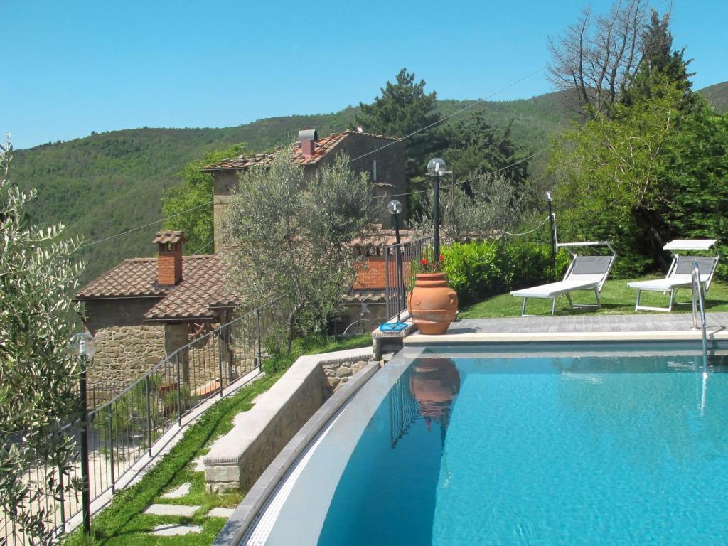 a swimming pool in front of a house at Holiday Home Capanna by Interhome in San Clemente in Valle