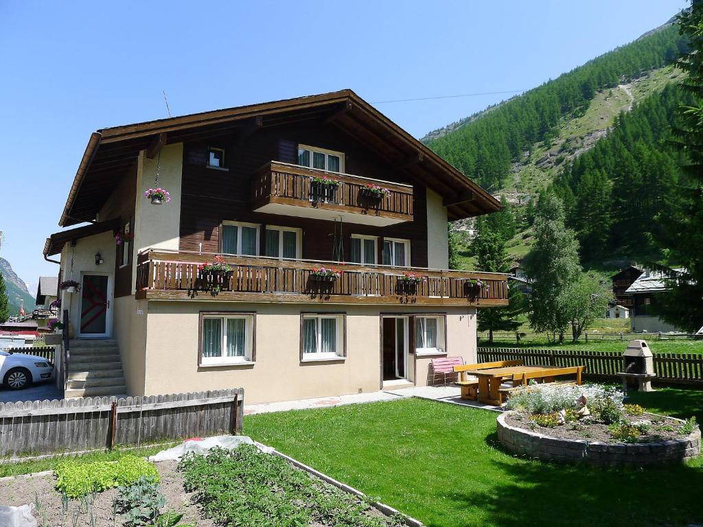 a large house with a balcony and a yard at Apartment Amara by Interhome in Saas-Fee