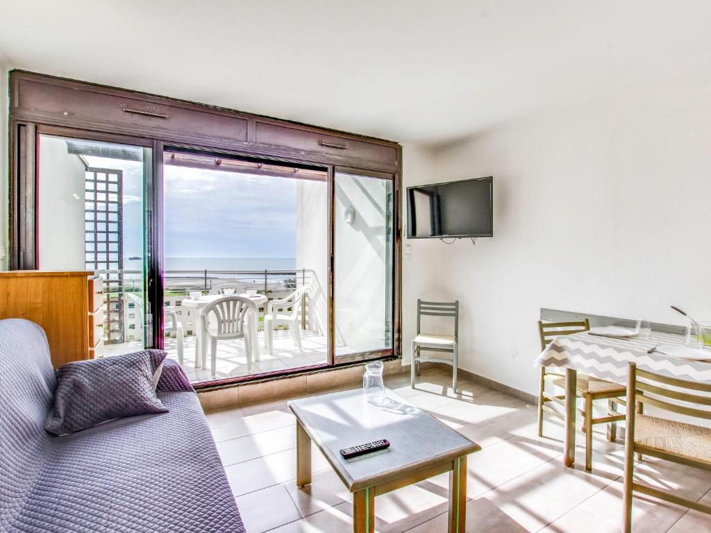 a living room with a couch and a table at Apartment Les Rivages de Rochelongue-4 by Interhome in Cap d'Agde