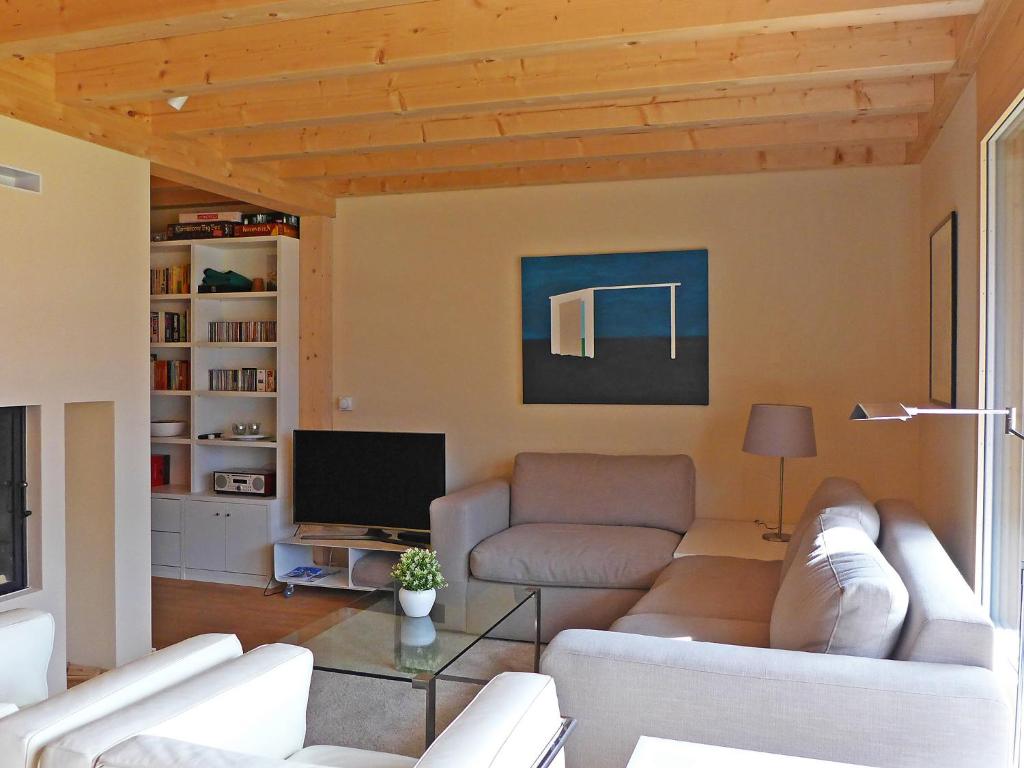 a living room with a couch and a tv at Apartment Bab-Port by Interhome in Wengen