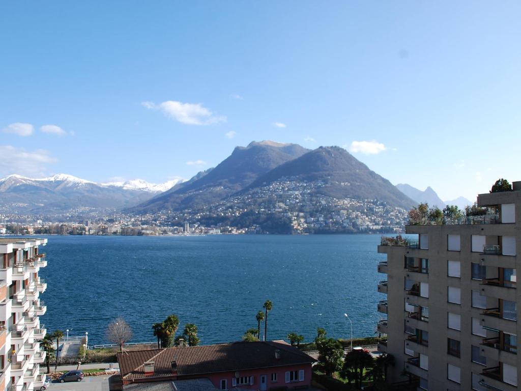 a view of a large body of water with mountains at Apartment App- Paradiso by Interhome in Paradiso