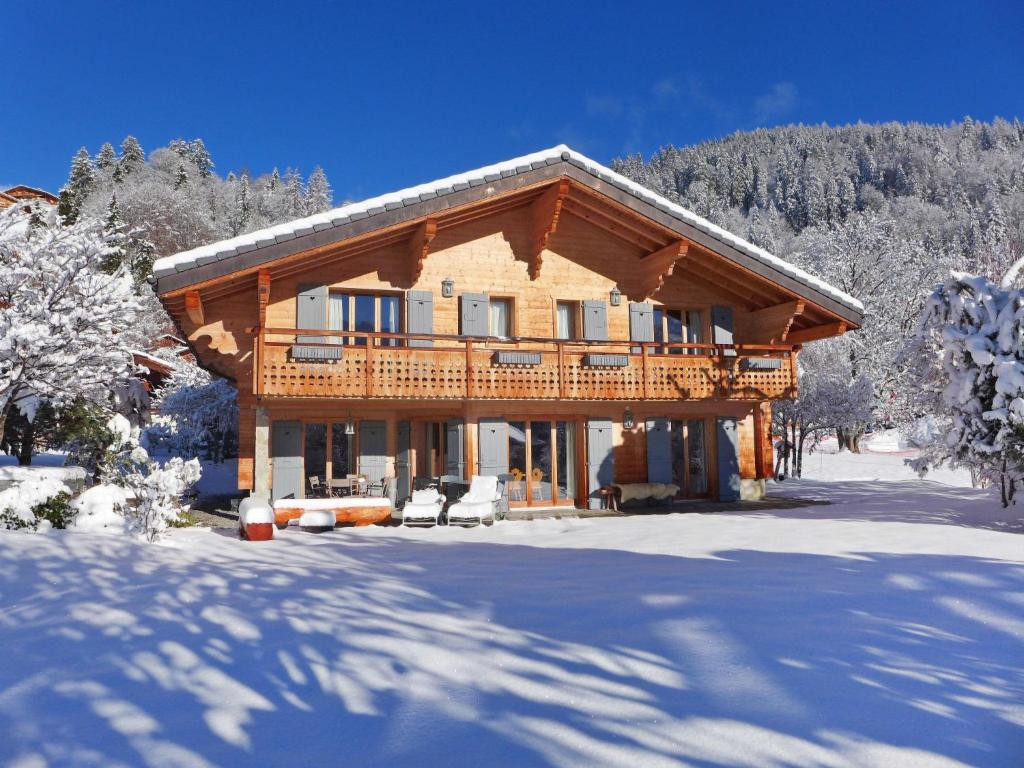 a log cabin in the snow with snow covered trees at Chalet Les 3 Soeurs by Interhome in Villars-sur-Ollon