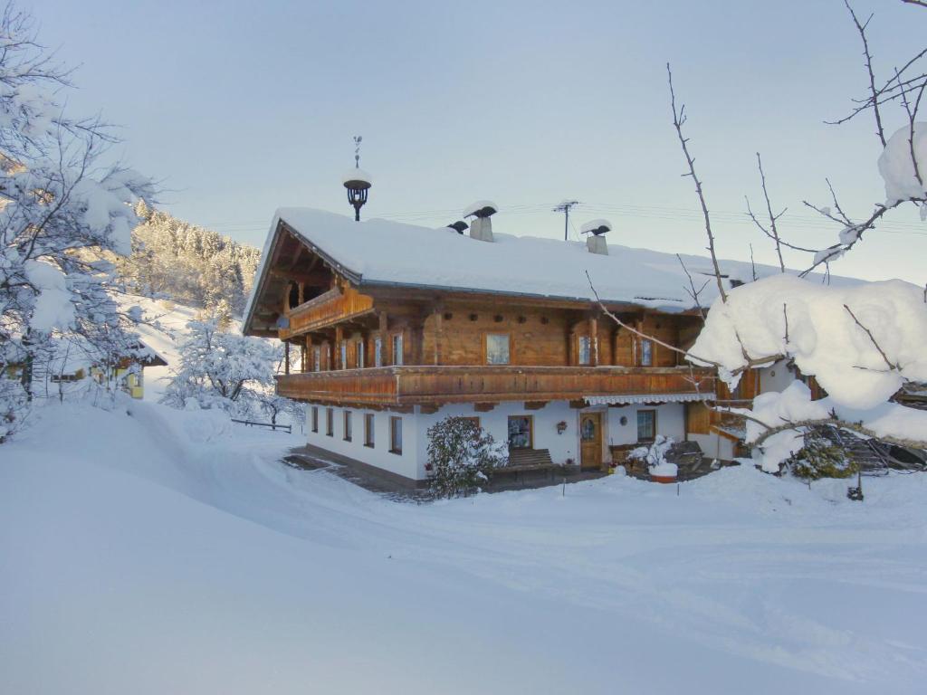 a large wooden house in the snow with snow at Apartment Untererhof-3 by Interhome in Pankrazberg