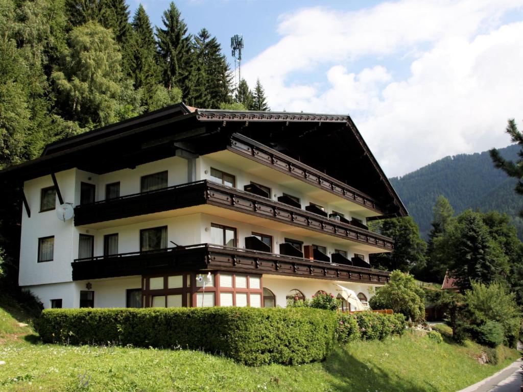 a building on a hill with grass and trees at Studio Edelweiss by Interhome in Obertschern