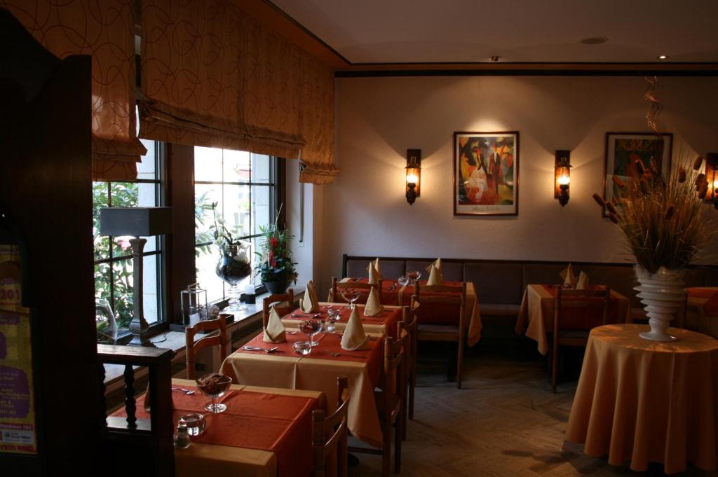 a dining room with tables and chairs in a restaurant at Le Pavillon in Echternach