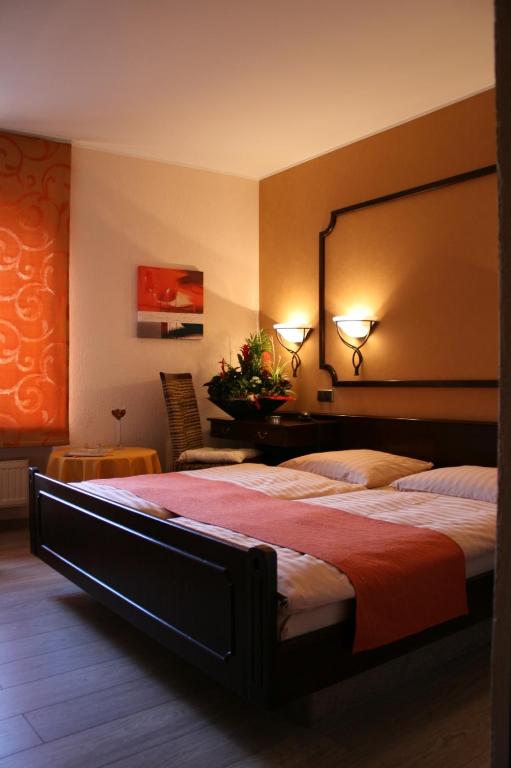 a bedroom with a large bed with a large headboard at Le Pavillon in Echternach