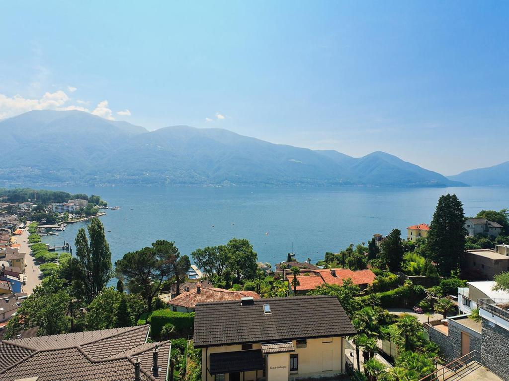 a view of a large body of water with mountains at Apartment Junior Suite Modern-20 by Interhome in Ascona