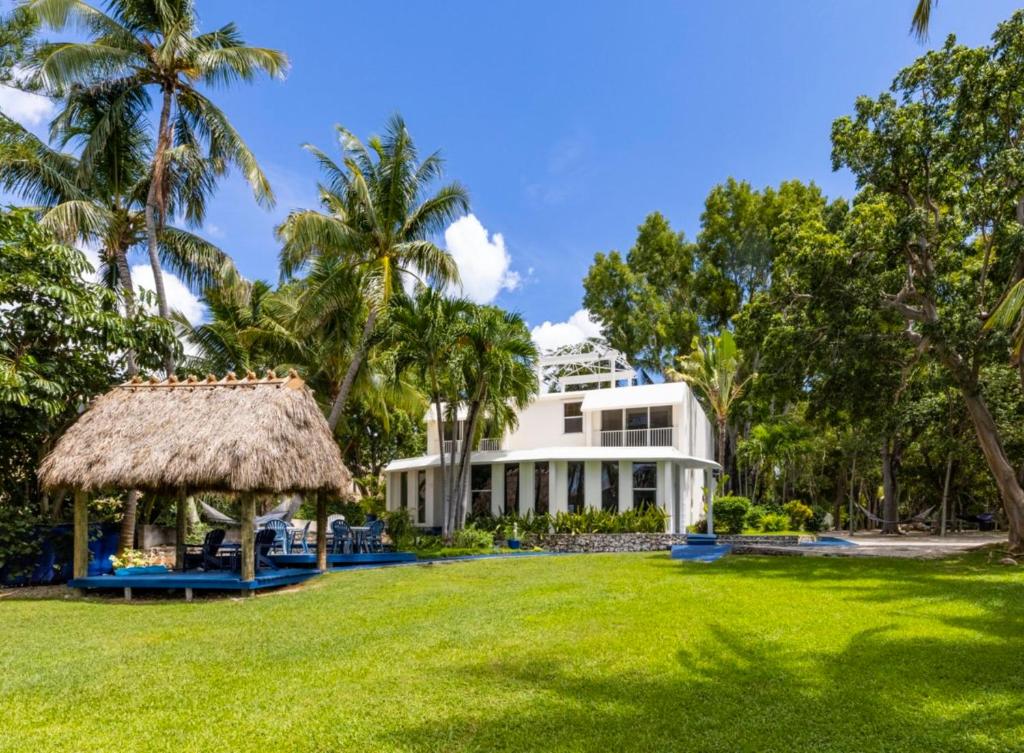 a large white building with a grass yard at Azul del Mar in Key Largo