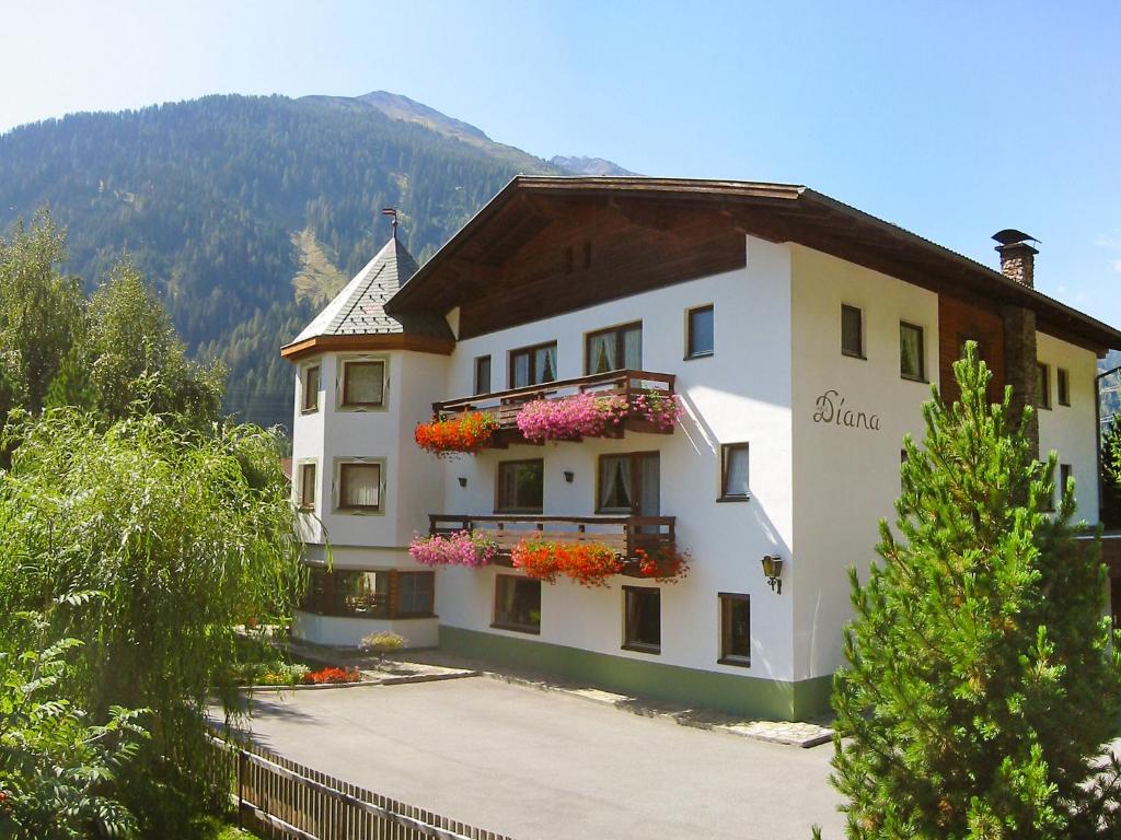 a large white building with flowers in the windows at Apartment Diana-1 by Interhome in Pettneu am Arlberg