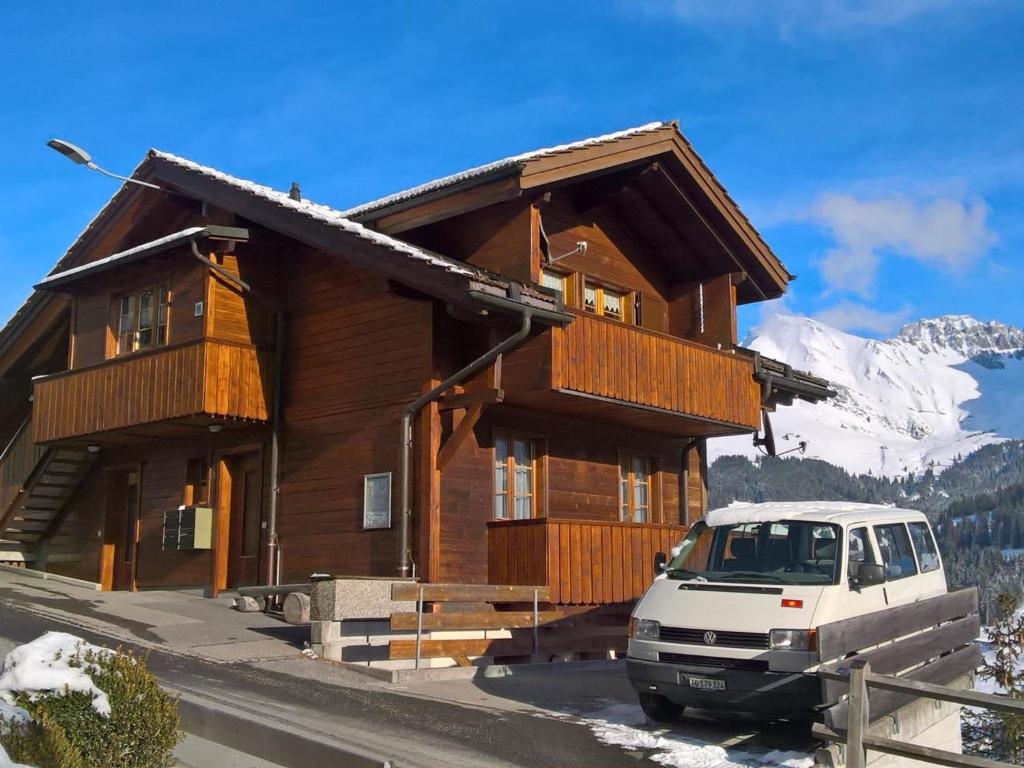 a house with a van parked in front of it at Apartment Adlerhorst by Interhome in Adelboden