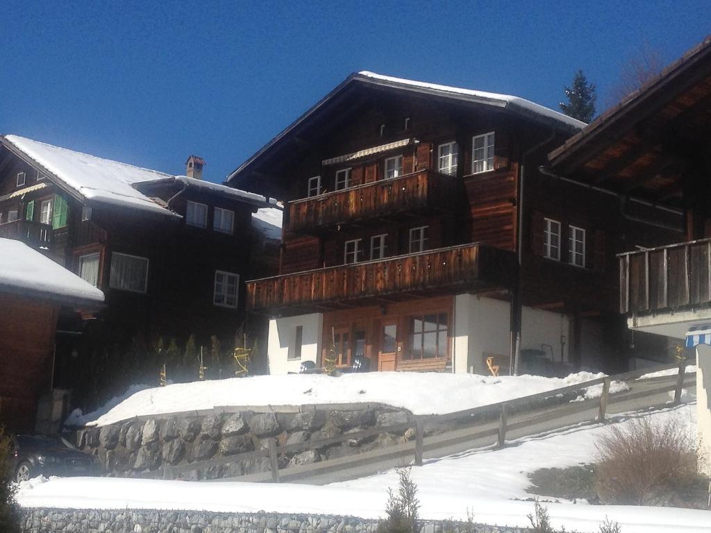 a large wooden building with snow on the ground at Apartment Chalet Almisräba by Interhome in Grindelwald