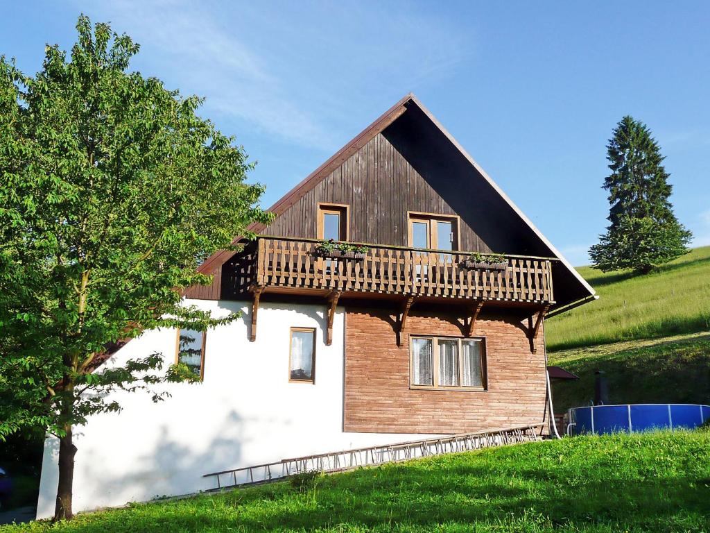 a house with a deck on the side of it at Apartment Janová by Interhome in Janová