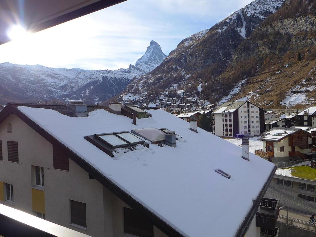 a building with snow on the roof with a mountain at Apartment Mirador-2 by Interhome in Zermatt