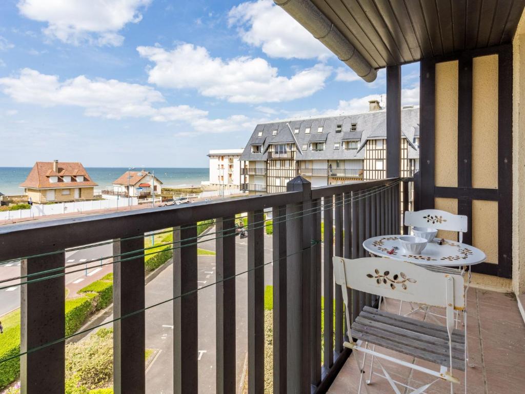 a balcony with a table and a view of the ocean at Apartment les Colombières by Interhome in Villers-sur-Mer