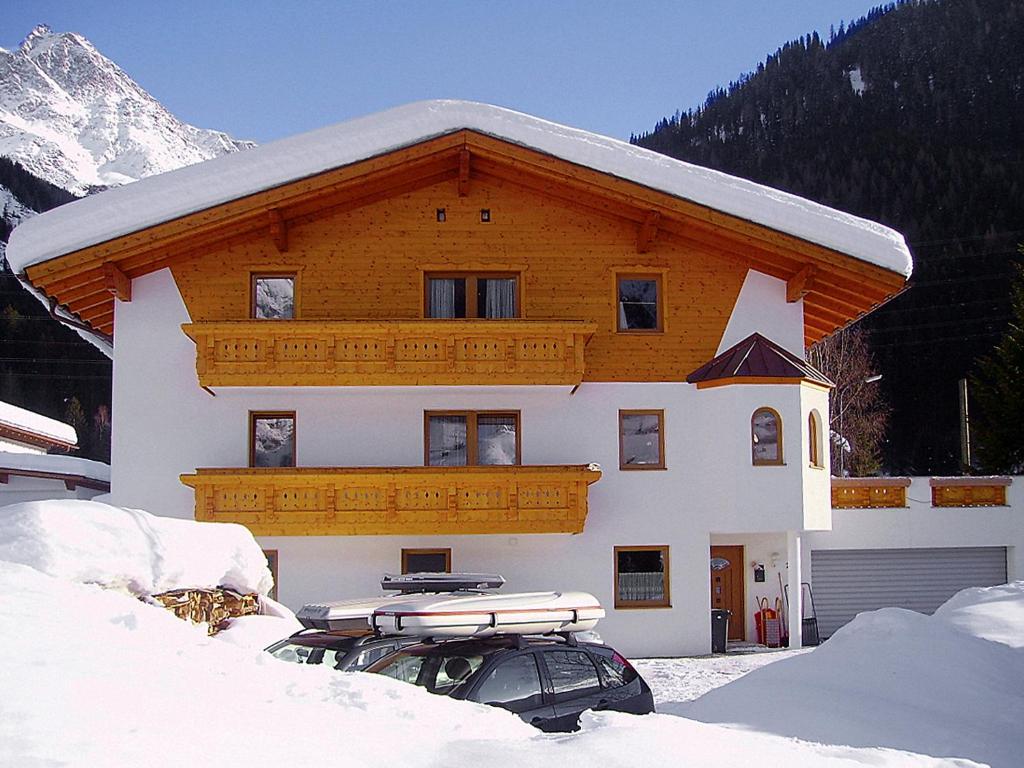 a house with a snow covered roof in the snow at Apartment Stark-2 by Interhome in Pettneu am Arlberg