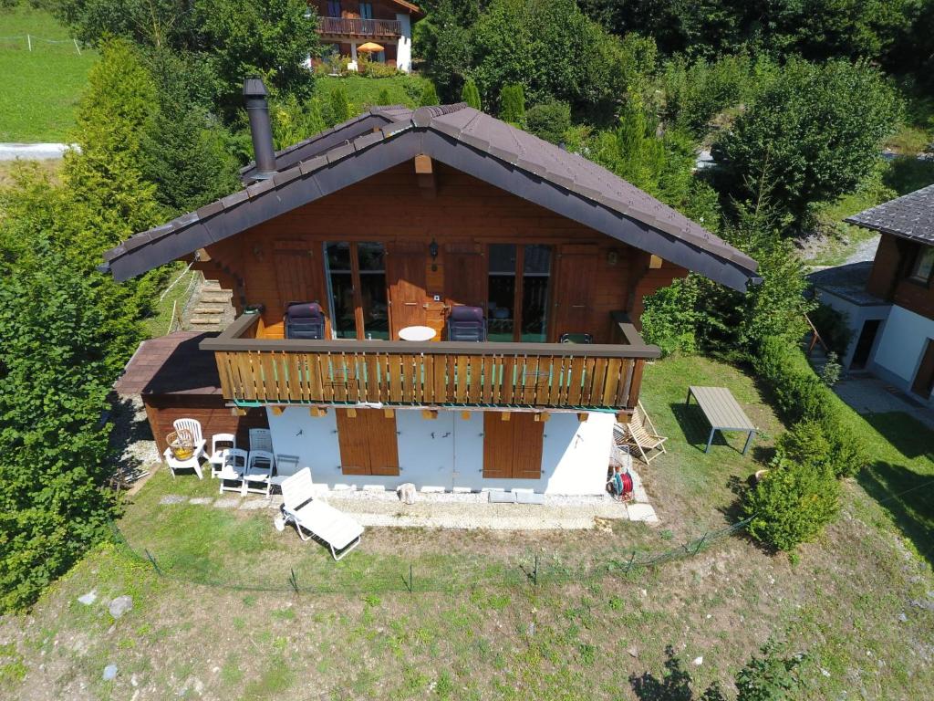 an aerial view of a log cabin with a deck at Chalet Ropiar by Interhome in Ovronnaz