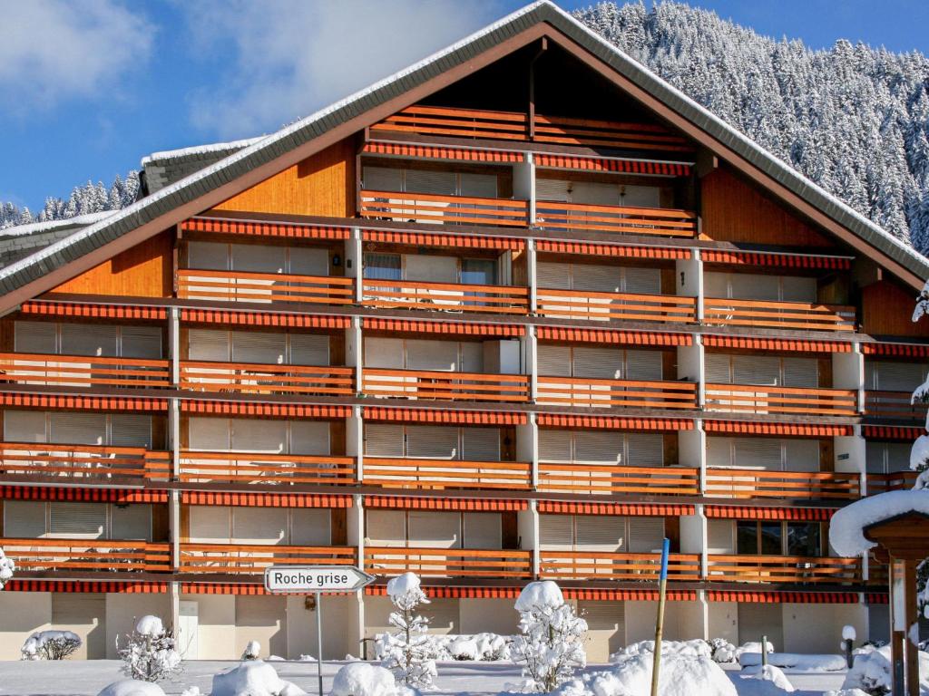 a large building with snow in front of it at Apartment Diamant 1 by Interhome in Villars-sur-Ollon