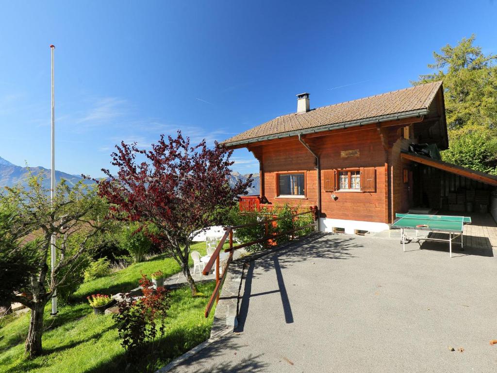 a house with a playground in front of it at Chalet Zan-Fleuron by Interhome in Arveyes