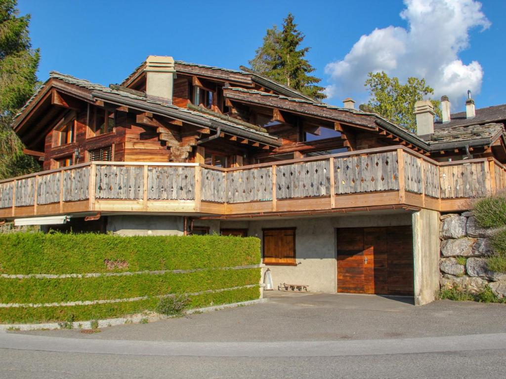a large wooden house with a large deck at Chalet Belle Vue by Interhome in Nendaz