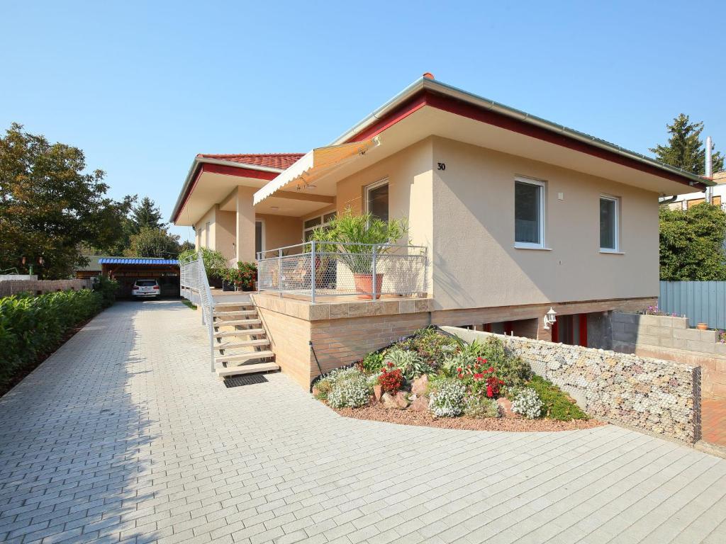 a house with a walkway in front of it at Apartment Beige by Interhome in Balatonszemes