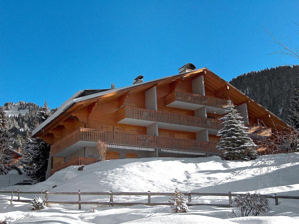 a large wooden building with snow in front of it at Apartment Cristel 2 by Interhome in Villars-sur-Ollon