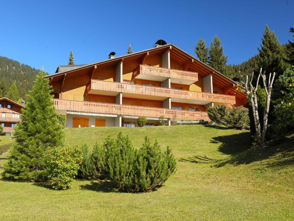 a large building on top of a hill with trees at Apartment Cristel 2 by Interhome in Villars-sur-Ollon