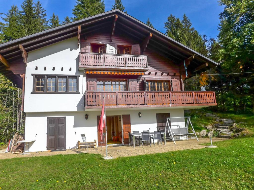 a log house with a balcony and a deck at Chalet L'Oiselet by Interhome in Villars-sur-Ollon