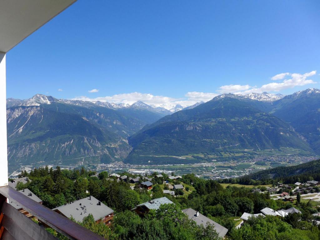 a view of a town with mountains in the background at Apartment Europa 2-1 by Interhome in Vermala