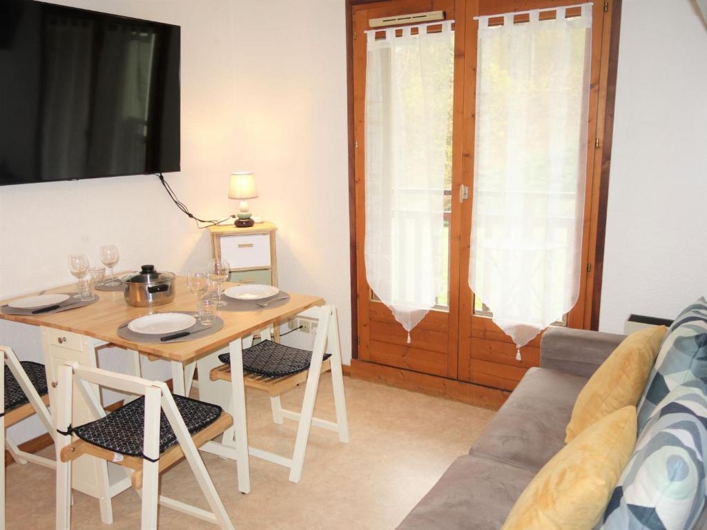 a living room with a table and a couch at Apartment La Piste-3 by Interhome in Saint-Gervais-les-Bains