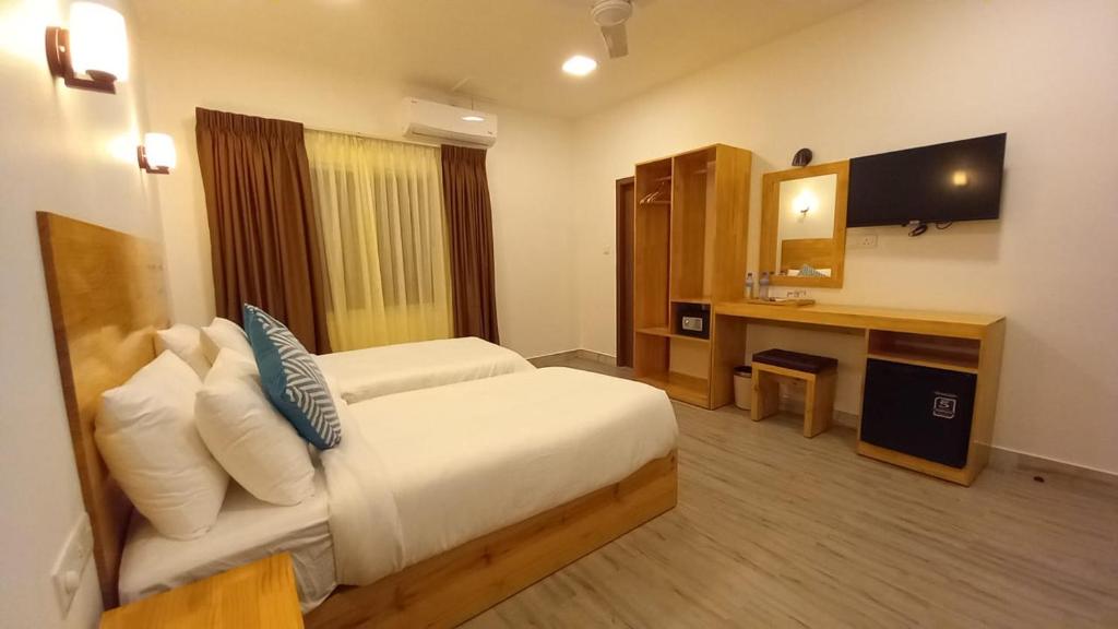 a hotel room with a bed and a mirror at Sky View by Relax Tours in Dhangethi