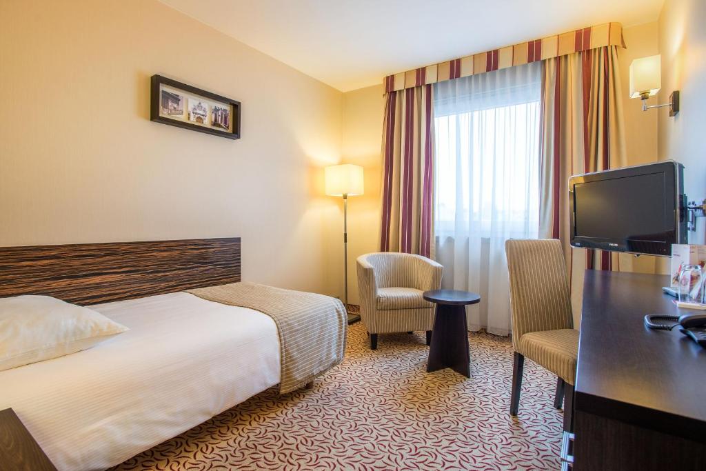 Postel nebo postele na pokoji v ubytování Qubus Hotel Kielce