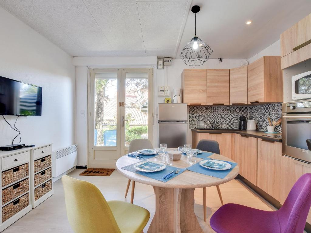 a kitchen with a table and chairs in a room at Apartment Villa au plus près by Interhome in Mimizan-Plage