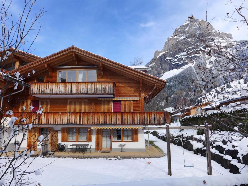 a log cabin in the mountains in the snow at Apartment Laerchehus Ost by Interhome in Kandersteg